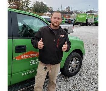 Male wearing a black SERVPRO jacket. He has short light brownish color hair and facial hair. 