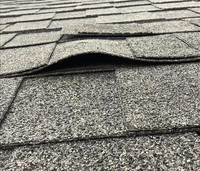 Grey Roof, shingles damaged by sever weather